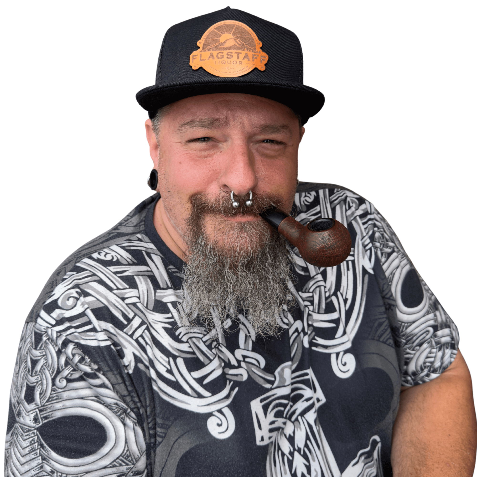 Man wearing Flagstaff Liquor leather patch hat (black) with patterned shirt, holding a pipe.