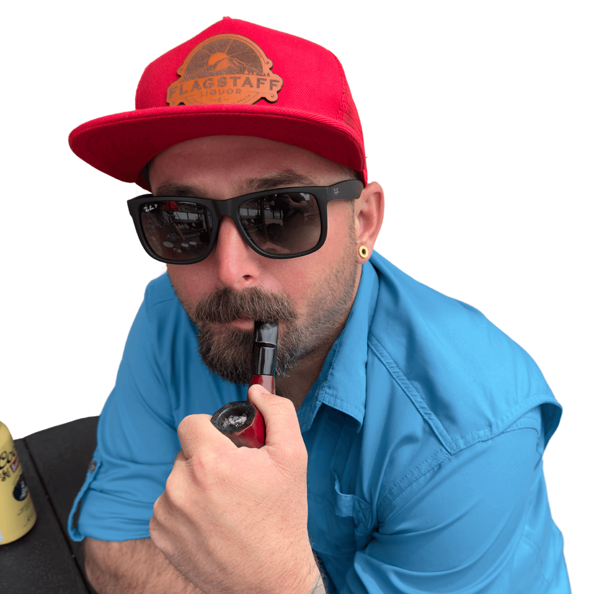 Man wearing a red Flagstaff Liquor leather patch hat and sunglasses, smoking a pipe.